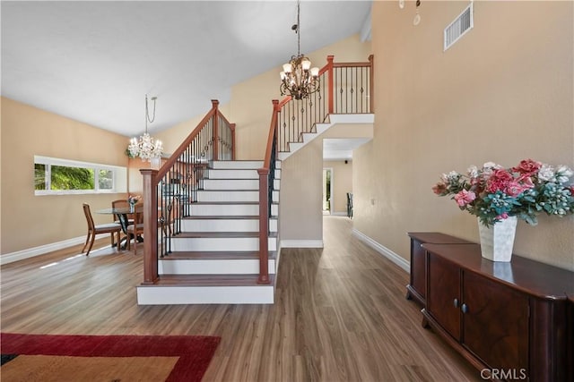 5706 E Bryce Ave, Orange, CA 92867 - stairway with a chandelier, wood finished floors, and high vaulted ceiling