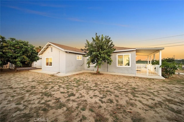 12077 Conference St, El Monte, CA 91732 - back of house at dusk featuring stucco siding