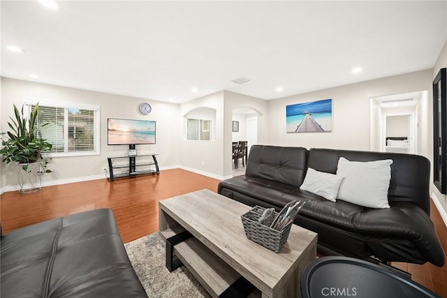 12077 Conference St, El Monte, CA 91732 - living area featuring wood finished floors, recessed lighting, and arched walkways