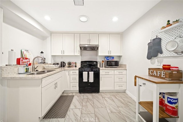 12077 Conference St, El Monte, CA 91732 - kitchen with black range with gas cooktop, stainless steel microwave, under cabinet range hood, white cabinetry, and light marble finish floors