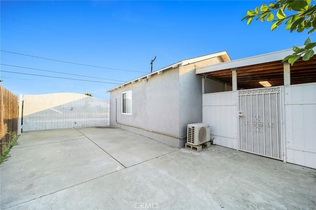12077 Conference St, El Monte, CA 91732 - view of side of home with a gate, stucco siding, and a patio