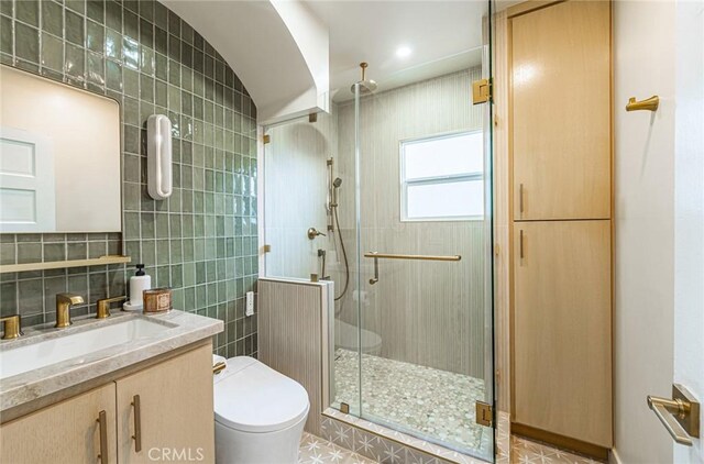 201 S Spruce St, Montebello, CA 90640 - full bathroom featuring vanity, tile walls, a stall shower, and tile patterned floors
