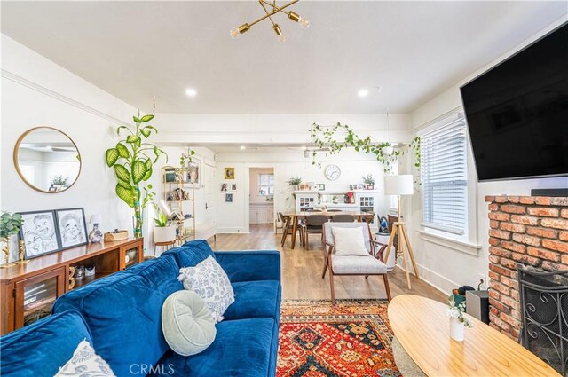 201 S Spruce St, Montebello, CA 90640 - living area with wood finished floors, recessed lighting, a chandelier, and a brick fireplace