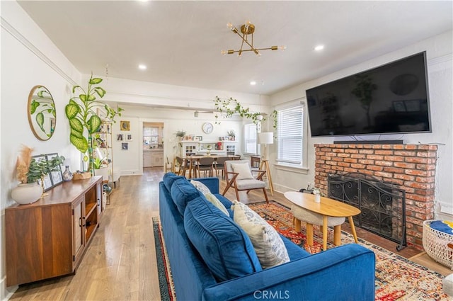 201 S Spruce St, Montebello, CA 90640 - living area featuring light wood-style flooring, recessed lighting, a brick fireplace, and a chandelier