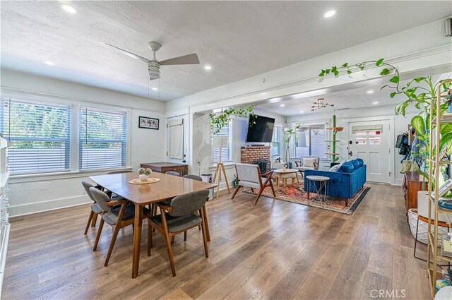 201 S Spruce St, Montebello, CA 90640 - dining area with ceiling fan, wood finished floors, recessed lighting, a brick fireplace, and a textured ceiling