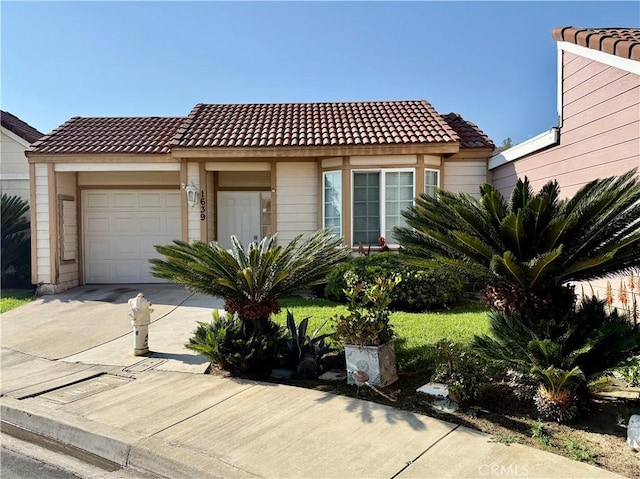 1639 Winn Ct, Pomona, CA 91768 - view of front of property featuring a tile roof, a garage, and driveway