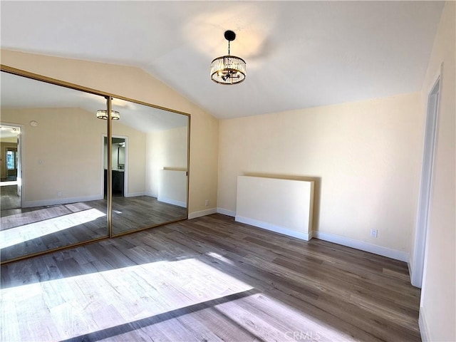 1639 Winn Ct, Pomona, CA 91768 - unfurnished room with lofted ceiling, wood finished floors, and a chandelier