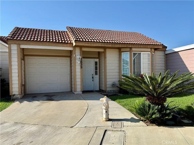 1639 Winn Ct, Pomona, CA 91768 - view of front of property featuring an attached garage, concrete driveway, and a tile roof