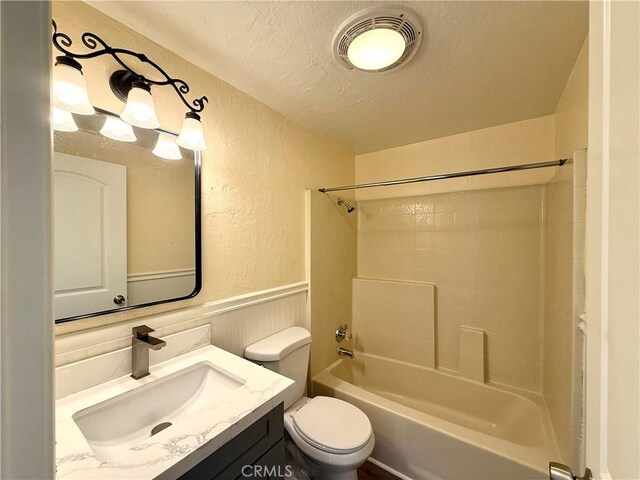 1639 Winn Ct, Pomona, CA 91768 - bathroom with a textured wall, a textured ceiling,  shower combination, vanity, and wainscoting