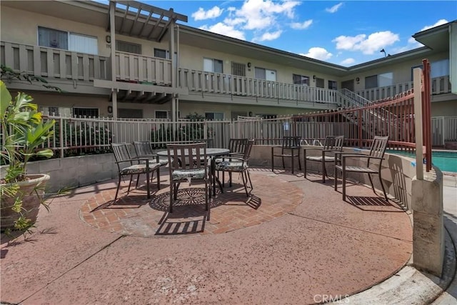 3265 Santa Fe Ave Unit 145, Long Beach, CA 90810 - view of patio featuring a community pool and outdoor dining area