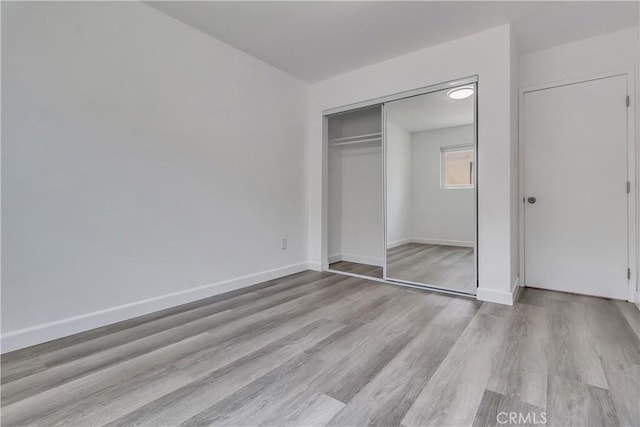3265 Santa Fe Ave Unit 145, Long Beach, CA 90810 - unfurnished bedroom featuring wood finished floors and a closet