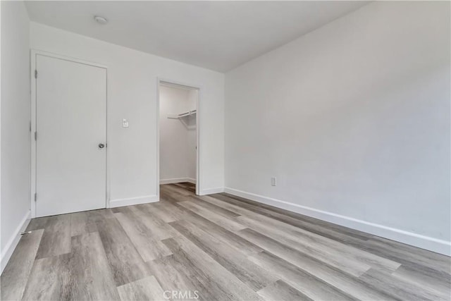 3265 Santa Fe Ave Unit 145, Long Beach, CA 90810 - unfurnished bedroom with wood finished floors, a closet, and a spacious closet