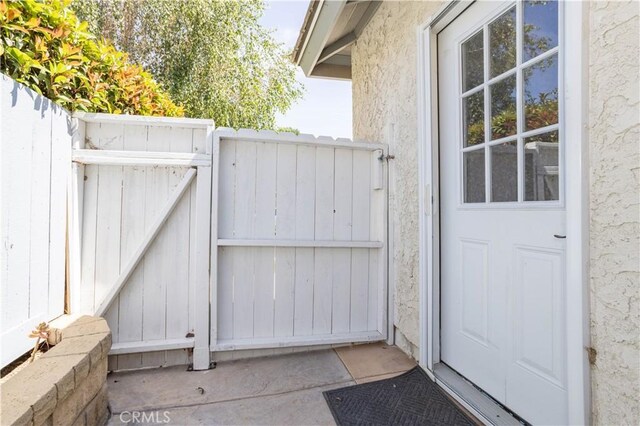 24302 Vista Ridge Dr, Valencia, CA 91355 - view of exterior entry with a gate and stucco siding