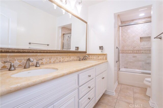 24302 Vista Ridge Dr, Valencia, CA 91355 - full bathroom featuring double vanity, tile patterned flooring, shower / bath combination with glass door, and backsplash