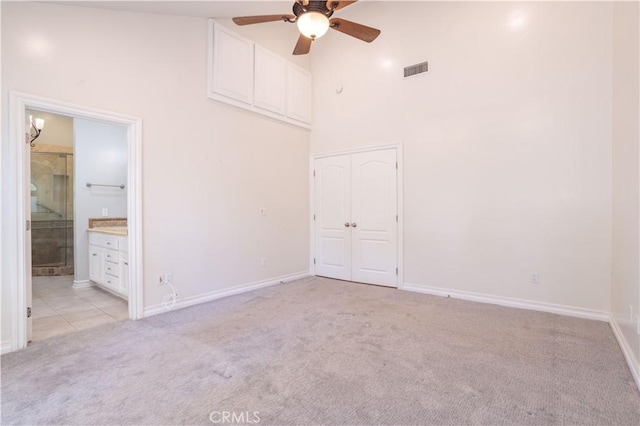 24302 Vista Ridge Dr, Valencia, CA 91355 - unfurnished bedroom featuring light colored carpet, a high ceiling, a closet, a ceiling fan, and ensuite bathroom