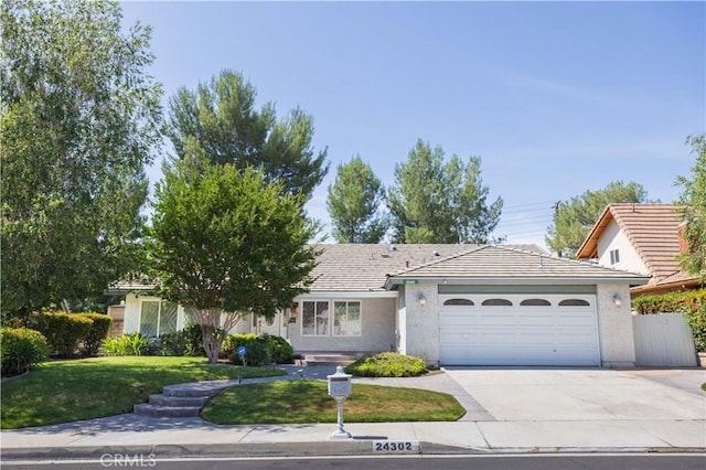 24302 Vista Ridge Dr, Valencia, CA 91355 - view of front of house with an attached garage, driveway, a front lawn, and stucco siding