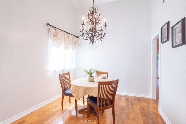 24302 Vista Ridge Dr, Valencia, CA 91355 - dining area featuring a chandelier, light wood finished floors, and a high ceiling