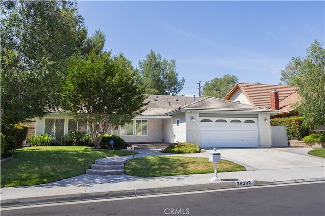 24302 Vista Ridge Dr, Valencia, CA 91355 - ranch-style home featuring a garage, driveway, a front yard, and stucco siding