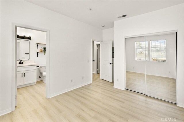 305 W Duarte Rd Unit G, Monrovia, CA 91016 - unfurnished bedroom featuring light wood-style flooring, a closet, and connected bathroom