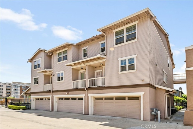 305 W Duarte Rd Unit G, Monrovia, CA 91016 - rear view of property with a garage, concrete driveway, and stucco siding
