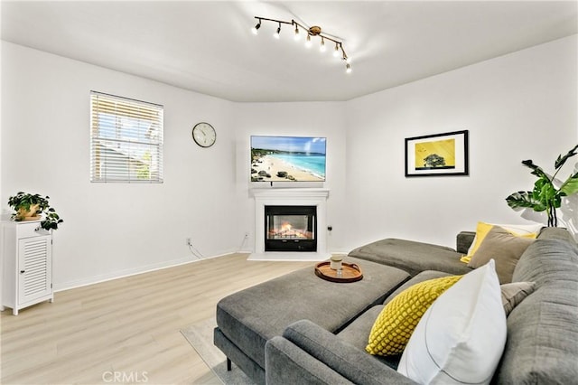 305 W Duarte Rd Unit G, Monrovia, CA 91016 - living area featuring track lighting, light wood-style flooring, and a glass covered fireplace