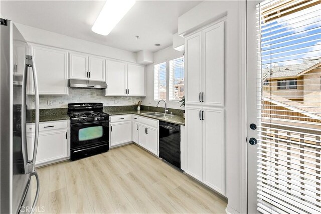 305 W Duarte Rd Unit G, Monrovia, CA 91016 - kitchen featuring black appliances, under cabinet range hood, white cabinets, light wood-type flooring, and tasteful backsplash