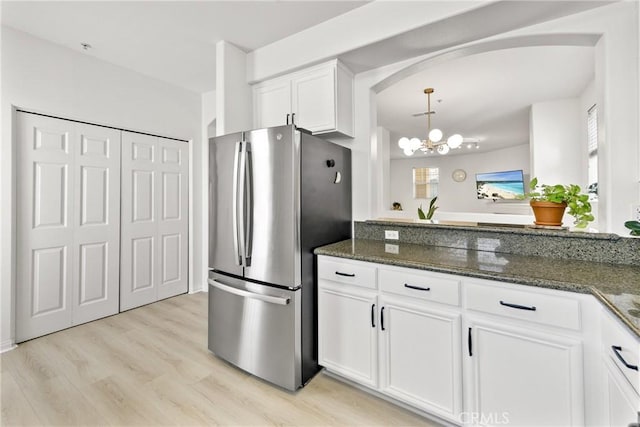 305 W Duarte Rd Unit G, Monrovia, CA 91016 - kitchen with freestanding refrigerator, a chandelier, white cabinetry, dark stone countertops, and light wood-type flooring