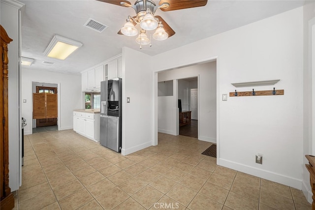 7028 E Parkcrest St, Long Beach, CA 90808 - kitchen with stainless steel refrigerator with ice dispenser, white cabinetry, light tile patterned floors, a ceiling fan, and light countertops