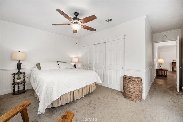 7028 E Parkcrest St, Long Beach, CA 90808 - bedroom with light carpet, crown molding, a closet, wainscoting, and ceiling fan