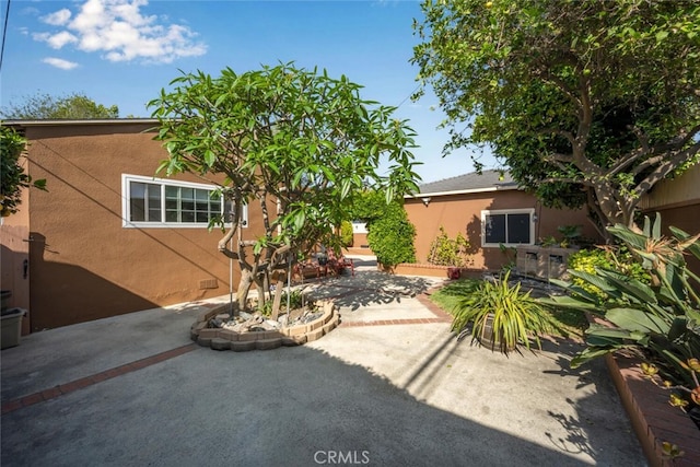 7028 E Parkcrest St, Long Beach, CA 90808 - rear view of property with stucco siding and a patio