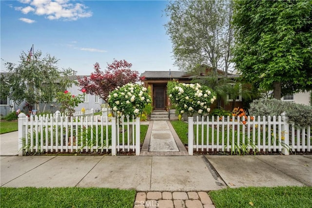 7028 E Parkcrest St, Long Beach, CA 90808 - view of property hidden behind natural elements with a fenced front yard
