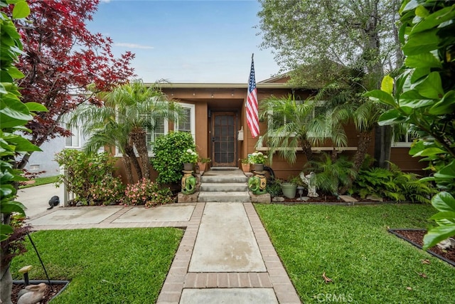 7028 E Parkcrest St, Long Beach, CA 90808 - view of front facade with a front yard and stucco siding