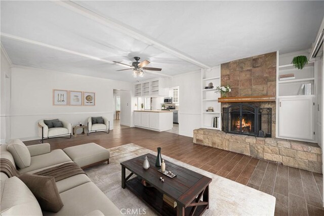 7028 E Parkcrest St, Long Beach, CA 90808 - living area featuring wood finished floors, a ceiling fan, a fireplace, and built in features