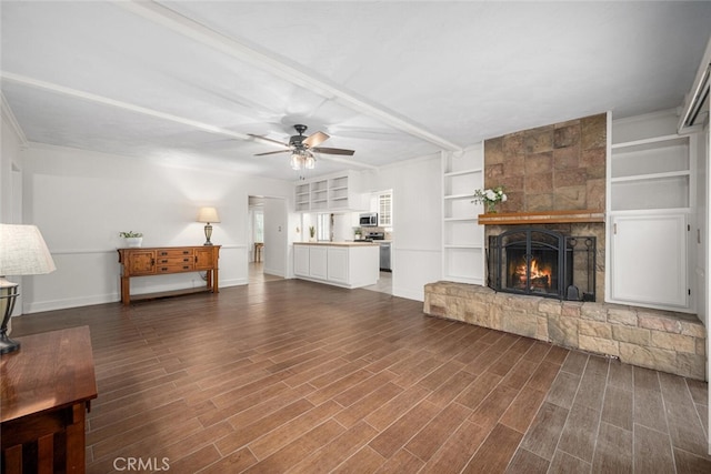 7028 E Parkcrest St, Long Beach, CA 90808 - unfurnished living room featuring a fireplace, a ceiling fan, dark wood finished floors, and built in shelves