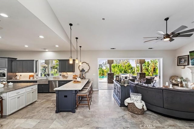 17180 Mockingbird Canyon Rd, Riverside, CA 92504 - kitchen featuring dishwasher, healthy amount of natural light, a peninsula, a breakfast bar area, and recessed lighting