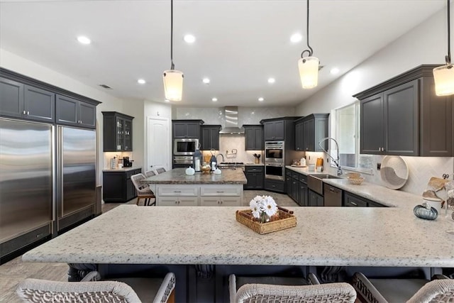 17180 Mockingbird Canyon Rd, Riverside, CA 92504 - kitchen featuring appliances with stainless steel finishes, a breakfast bar, light stone countertops, and recessed lighting