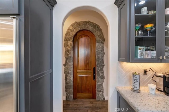 17180 Mockingbird Canyon Rd, Riverside, CA 92504 - hallway featuring dark wood-style floors and arched walkways