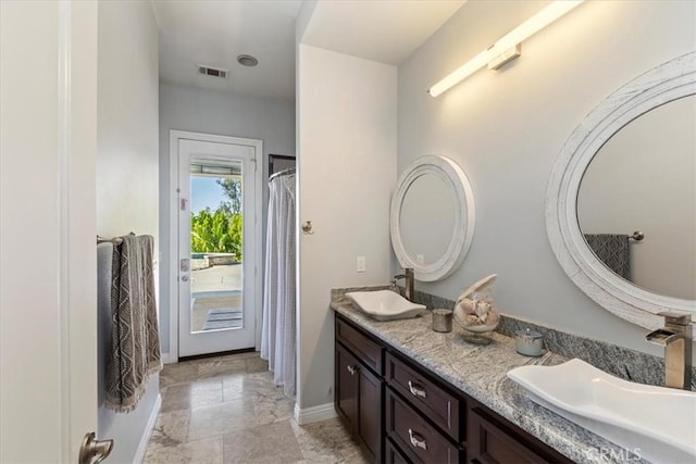 17180 Mockingbird Canyon Rd, Riverside, CA 92504 - bathroom featuring double vanity and baseboards