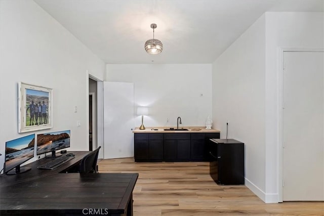 17180 Mockingbird Canyon Rd, Riverside, CA 92504 - office area with light wood-style flooring and bar with sink