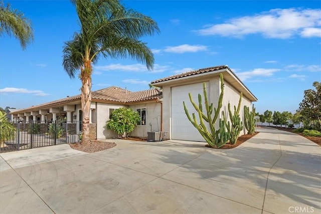17180 Mockingbird Canyon Rd, Riverside, CA 92504 - mediterranean / spanish-style home with concrete driveway, stucco siding, a tile roof, and a garage