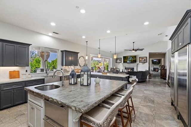 17180 Mockingbird Canyon Rd, Riverside, CA 92504 - kitchen featuring built in refrigerator, a kitchen island with sink, open floor plan, ceiling fan, and recessed lighting