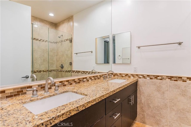 5151 Balboa Blvd Unit 104, Encino, CA 91316 - bathroom featuring tile walls, a shower stall, double vanity, a wainscoted wall, and recessed lighting
