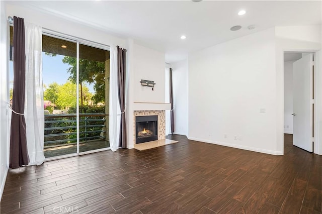 5151 Balboa Blvd Unit 104, Encino, CA 91316 - unfurnished living room featuring dark wood-style flooring, healthy amount of natural light, a fireplace with flush hearth, and recessed lighting