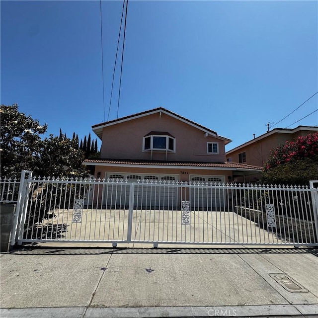 7842 Cypress Dr, Huntington Beach, CA 92647 - view of front of home featuring stucco siding and driveway