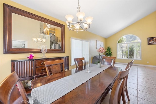 566 Bruin Dr, Riverside, CA 92507 - dining space with a chandelier, vaulted ceiling, and stone tile flooring