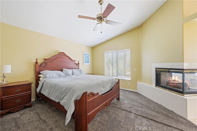 566 Bruin Dr, Riverside, CA 92507 - carpeted bedroom with lofted ceiling, a tile fireplace, and a ceiling fan