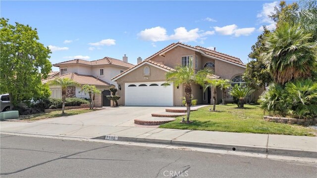 566 Bruin Dr, Riverside, CA 92507 - mediterranean / spanish home with stucco siding, a garage, driveway, a front lawn, and a tiled roof