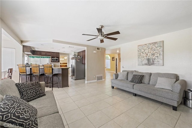 566 Bruin Dr, Riverside, CA 92507 - living area featuring light tile patterned floors and ceiling fan