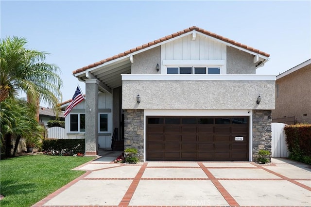 5302 Bryant Cir, Westminster, CA 92683 - view of front facade featuring stone siding, stucco siding, a tiled roof, and concrete driveway