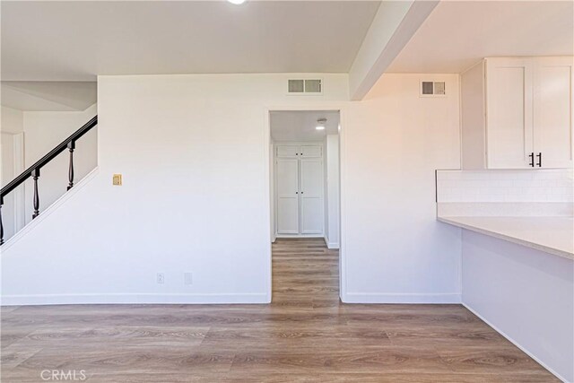 1510 W 147th St, Gardena, CA 90247 - unfurnished dining area with light wood-style floors and stairs